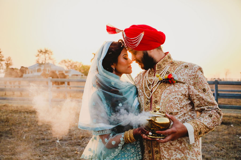 Brisbane Wedding Planner | Indian Bride and Groom holding magic lamp with smoke coming out of it