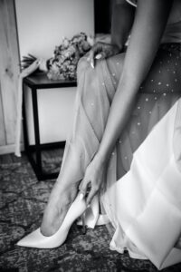 Bride putting on her heels