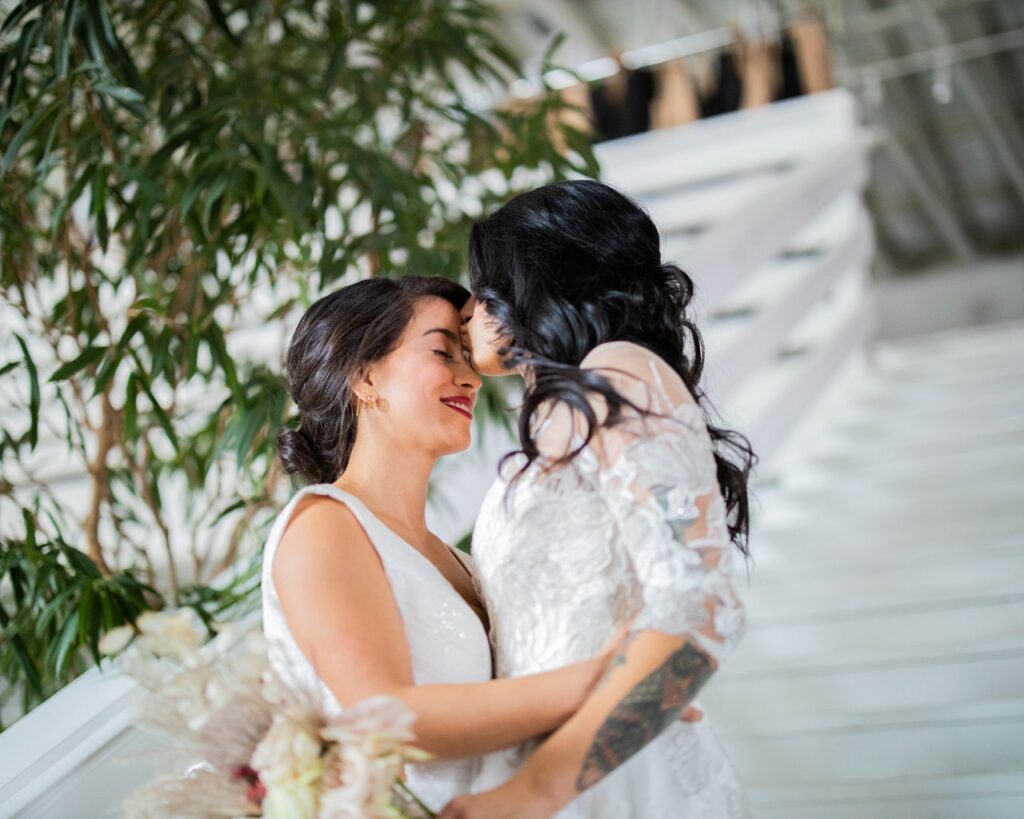 2 brides kissing at their wedding venue